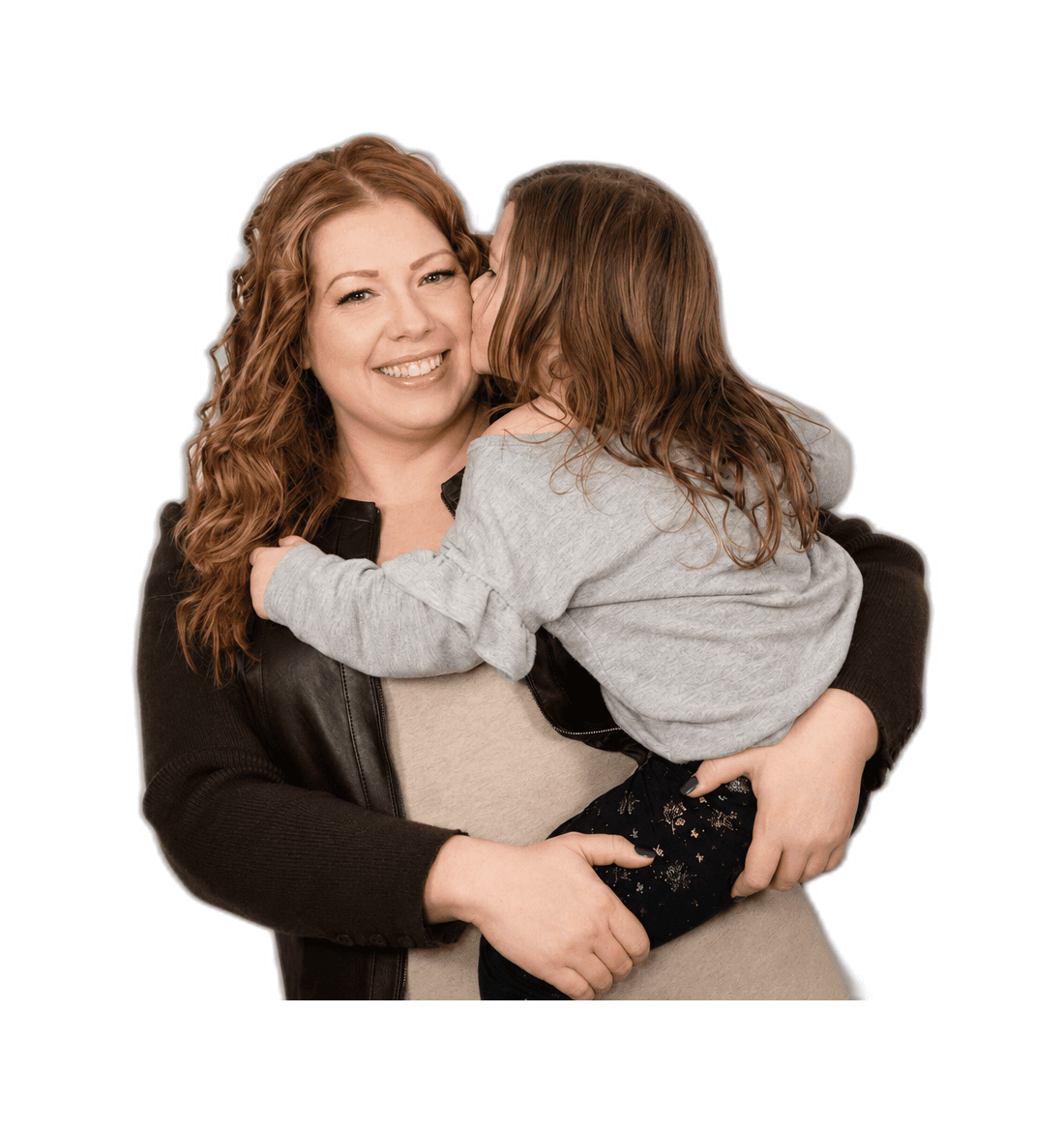 Racheal Blackmore holding one of her kids, who is kissing her cheek.